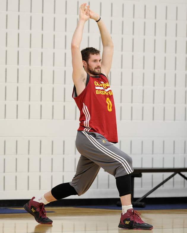 Cleveland Cavaliers forward Kevin Love stretches to loosen up his muscles prior to a team practice.